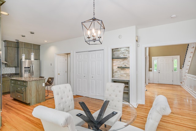 127 Hanover Rd, Newtown, CT 06470 - dining room with light wood-style flooring, a chandelier, stairway, and recessed lighting