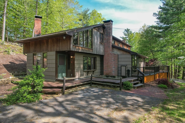 161 Center Hill Rd, Barkhamsted, CT 06063 - view of front facade featuring a chimney and a wooden deck