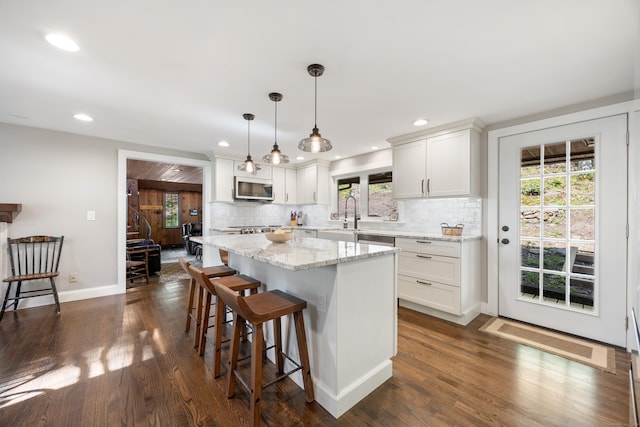 161 Center Hill Rd, Barkhamsted, CT 06063 - kitchen featuring appliances with stainless steel finishes, a breakfast bar, backsplash, recessed lighting, and dark wood-style flooring
