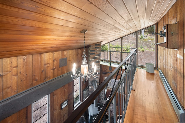 161 Center Hill Rd, Barkhamsted, CT 06063 - hallway with baseboard heating, wood ceiling, wood walls, a chandelier, and wood finished floors