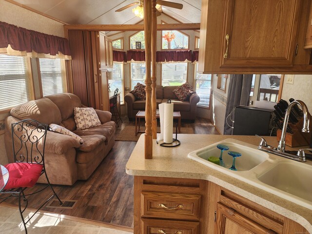 42 Pierce Rd, Preston, CT 06365 - kitchen with lofted ceiling, a sink, brown cabinets, light countertops, and a ceiling fan