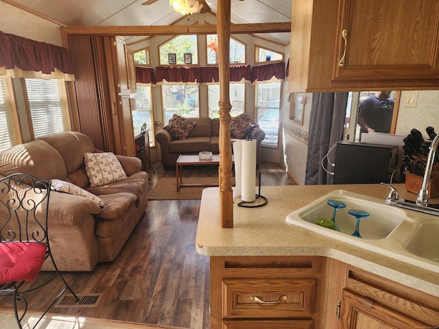 42 Pierce Rd, Preston, CT 06365 - kitchen featuring vaulted ceiling, light countertops, a sink, brown cabinetry, and open floor plan