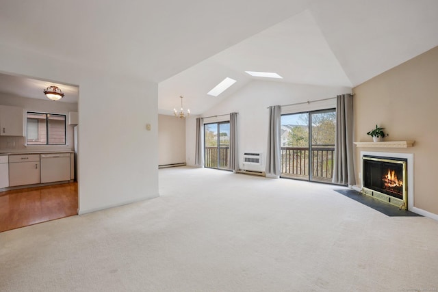 97 Richards Ave Apt F5, Norwalk, CT 06854 - unfurnished living room featuring an inviting chandelier, light carpet, baseboards, a fireplace with flush hearth, and lofted ceiling with skylight