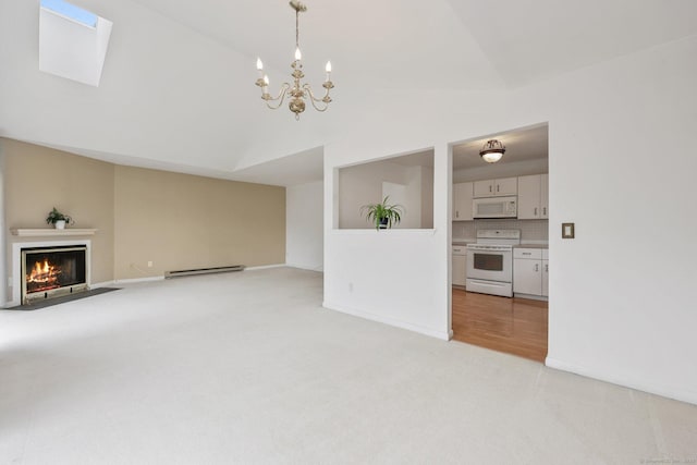 97 Richards Ave Apt F5, Norwalk, CT 06854 - unfurnished living room featuring light colored carpet, a fireplace with flush hearth, a skylight, a baseboard radiator, and an inviting chandelier