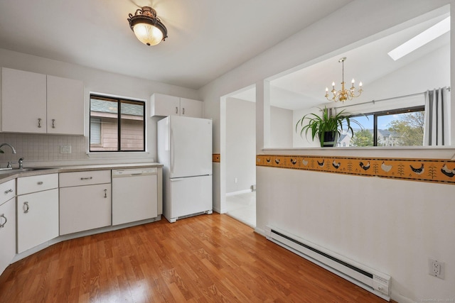 97 Richards Ave Apt F5, Norwalk, CT 06854 - kitchen with a sink, baseboard heating, white appliances, light countertops, and light wood-style flooring