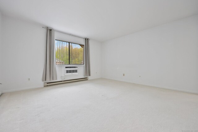 97 Richards Ave Apt F5, Norwalk, CT 06854 - spare room featuring baseboards, a baseboard heating unit, a wall mounted AC, and carpet
