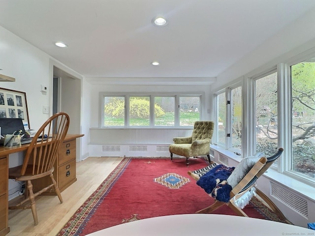 sunroom / solarium with wood finished floors and recessed lighting