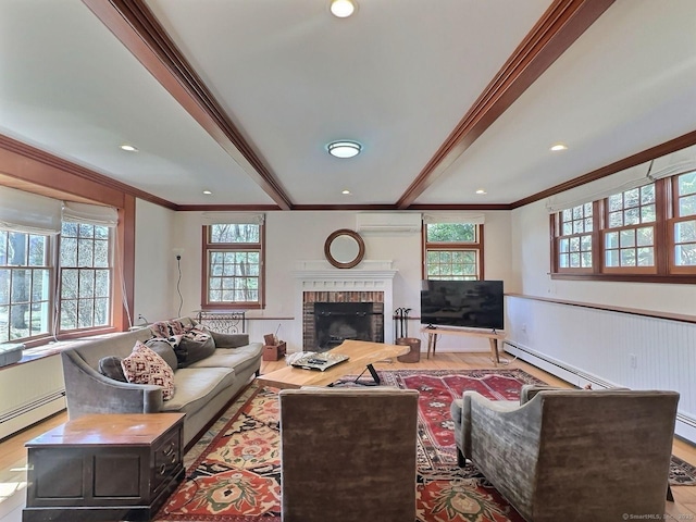 living area with ornamental molding, a wall mounted AC, plenty of natural light, a baseboard heating unit, and wood finished floors