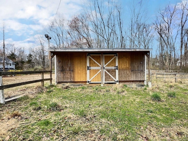 view of shed with fence