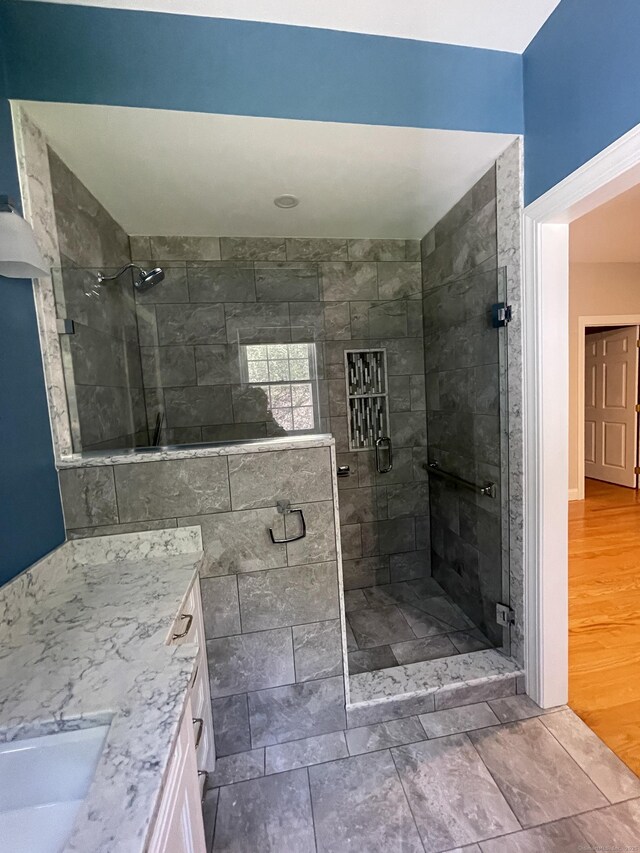 full bathroom featuring a shower stall and vanity