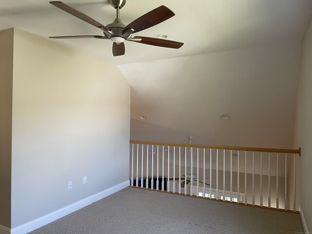 carpeted spare room with baseboards and a ceiling fan
