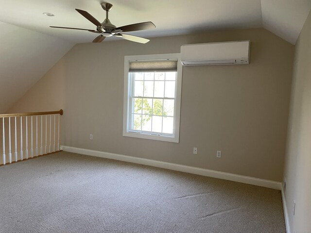 additional living space featuring lofted ceiling, baseboards, ceiling fan, an AC wall unit, and carpet flooring