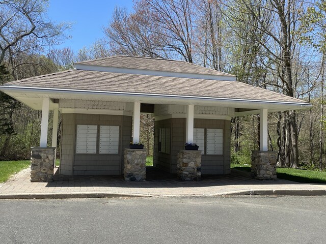 view of home's community with a garage and mail area
