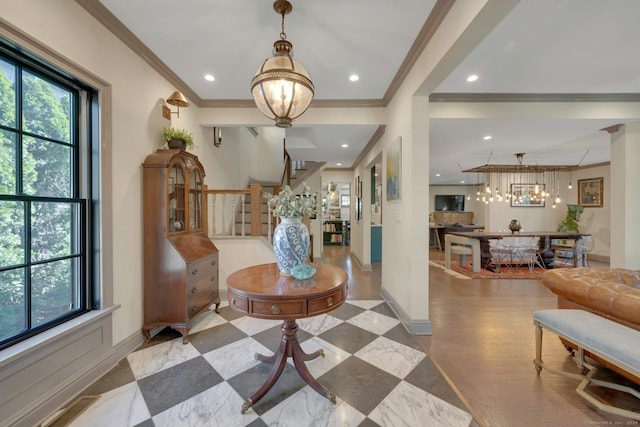 foyer entrance with crown molding, recessed lighting, baseboards, and a notable chandelier