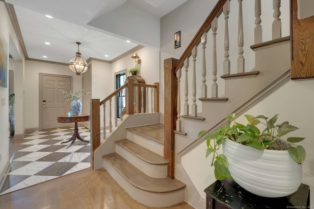 stairway with baseboards, ornamental molding, and recessed lighting