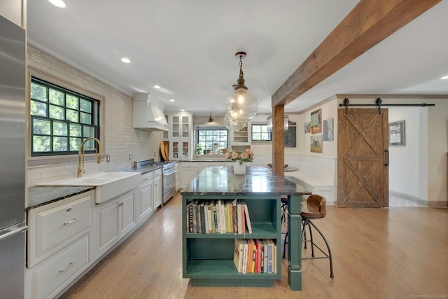 kitchen with white cabinets, high quality appliances, open shelves, and custom exhaust hood