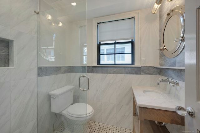 bathroom with toilet, tile patterned floors, tile walls, and vanity