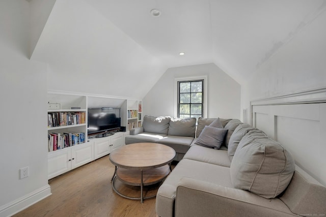 living area with recessed lighting, lofted ceiling, and light wood-style floors