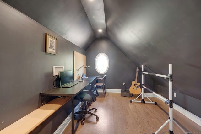 office area with baseboards, vaulted ceiling, and wood finished floors
