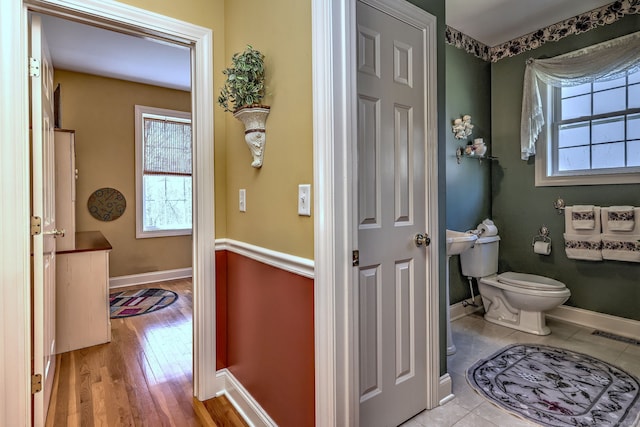 bathroom featuring toilet, baseboards, visible vents, and wood finished floors