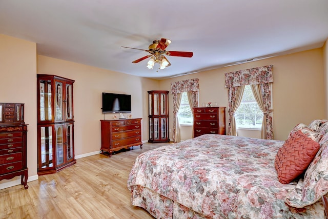 bedroom featuring baseboards, a ceiling fan, and wood finished floors