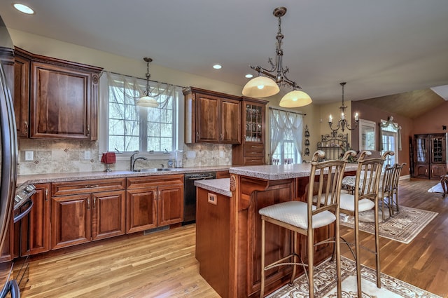 kitchen featuring a sink, plenty of natural light, black dishwasher, and light wood finished floors