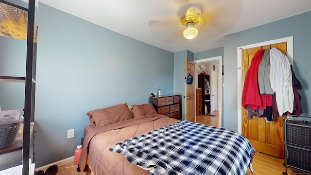 bedroom with light wood-type flooring and a ceiling fan