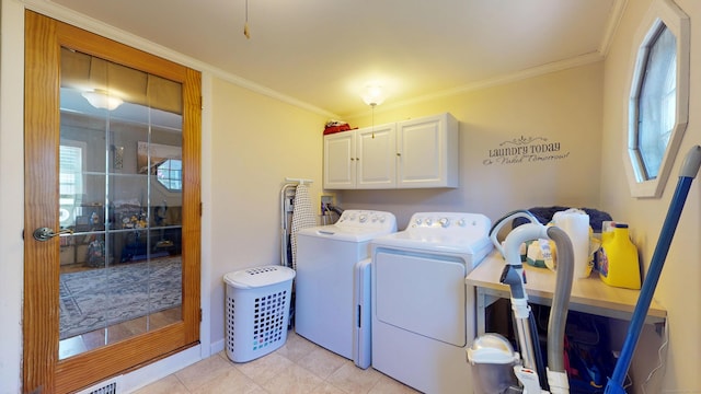 laundry room featuring cabinet space, washer and dryer, ornamental molding, plenty of natural light, and light tile patterned floors