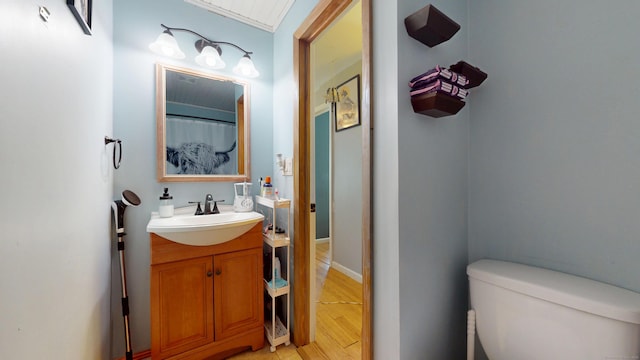 full bath with vanity, toilet, and wood finished floors