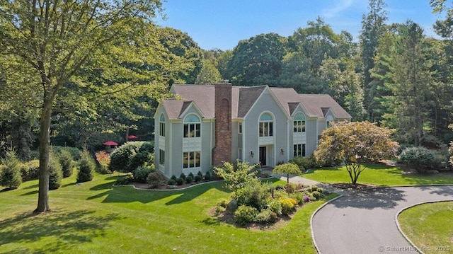 81 Silver Hill Rd, Ridgefield, CT 06877 - view of front facade with a front yard and a chimney