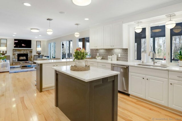 81 Silver Hill Rd, Ridgefield, CT 06877 - kitchen with a sink, dishwasher, white cabinets, and a fireplace