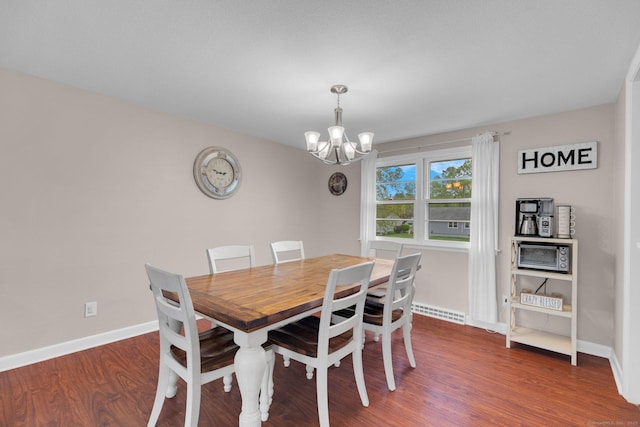 dining area with a chandelier, wood finished floors, and baseboards