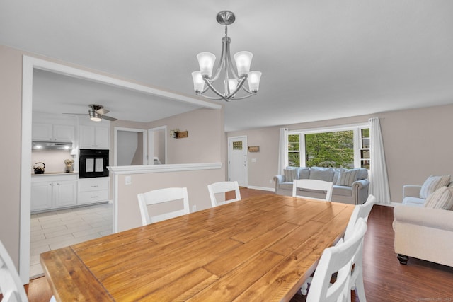 dining space featuring a chandelier and ceiling fan
