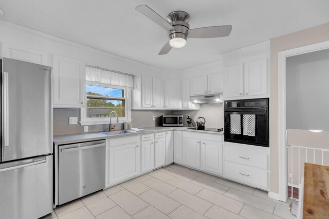 kitchen featuring black appliances, a sink, light countertops, white cabinetry, and a ceiling fan