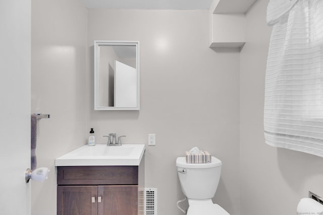 bathroom featuring toilet and vanity