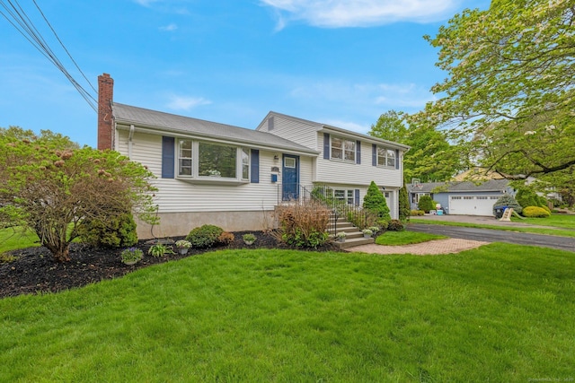 split level home with a chimney and a front lawn