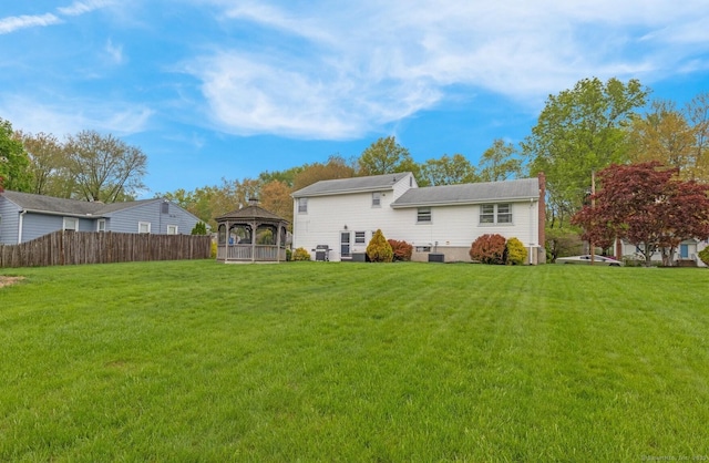back of property with a gazebo