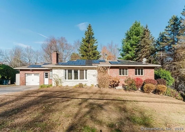 1848 Waterbury Rd, Cheshire, CT 06410 - ranch-style home with a garage, roof mounted solar panels, brick siding, and a chimney