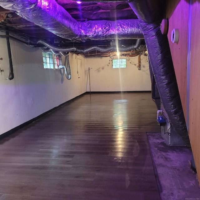 1848 Waterbury Rd, Cheshire, CT 06410 - basement with healthy amount of natural light, wood finished floors, and baseboards