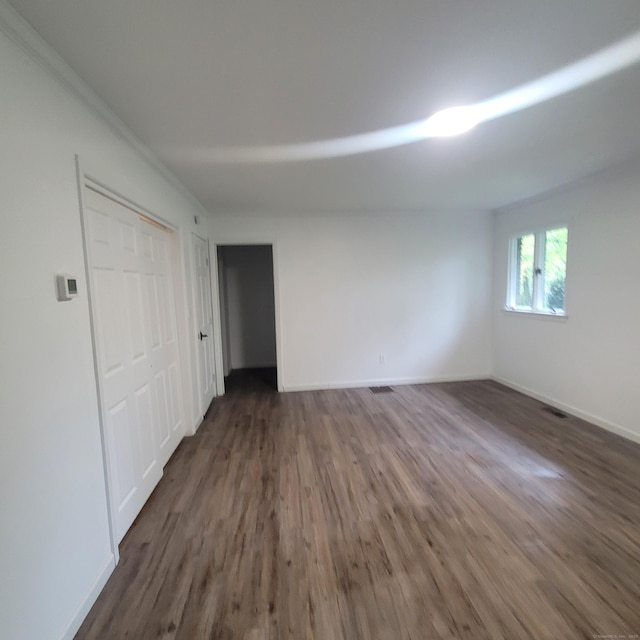 1848 Waterbury Rd, Cheshire, CT 06410 - unfurnished bedroom with dark wood-style floors and baseboards