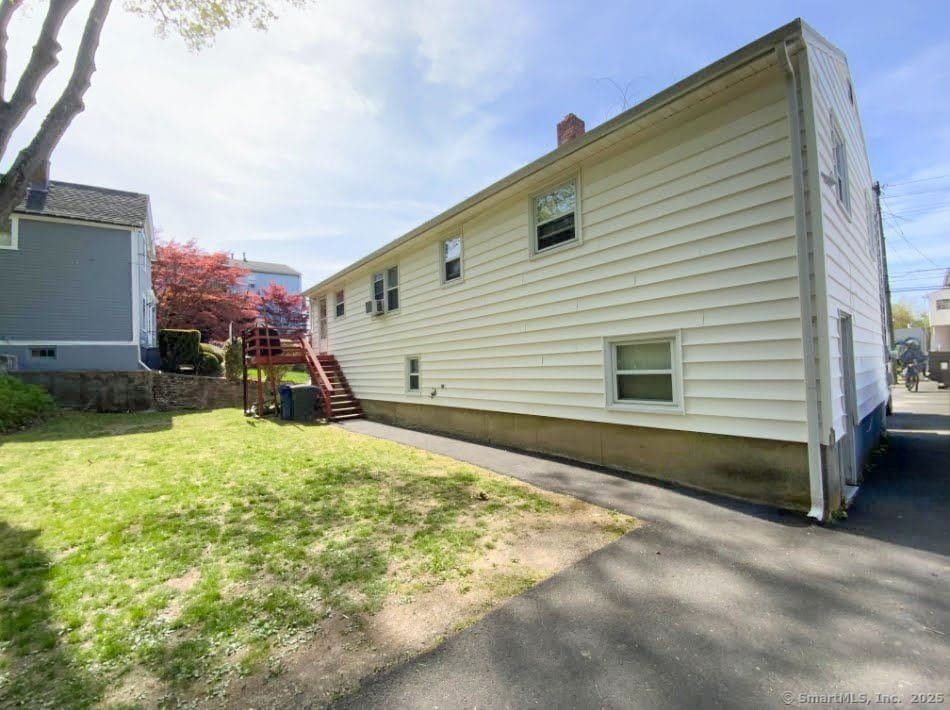 456 Main St, West Haven, CT 06516 - rear view of house featuring stairway, a yard, and a chimney