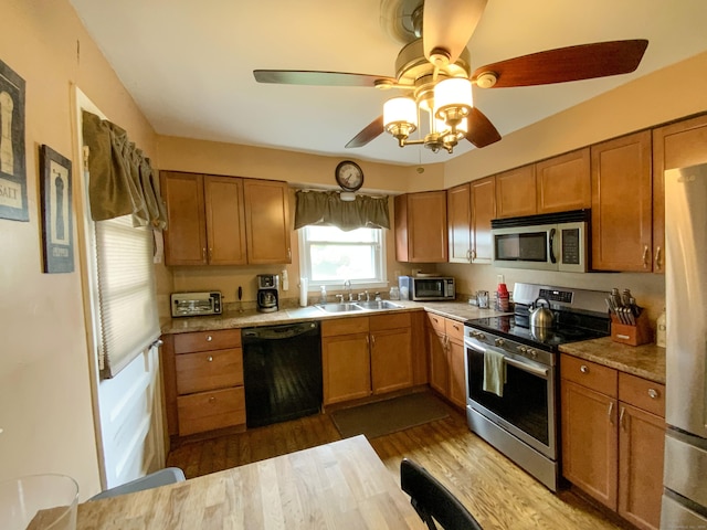 456 Main St, West Haven, CT 06516 - kitchen featuring stainless steel appliances, a sink, brown cabinets, and dark wood-type flooring