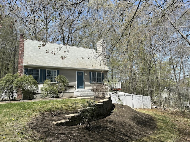 view of front of property with fence and a chimney