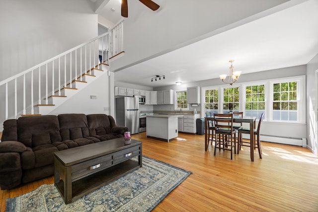 1343 Baldwin Hill Rd, Ledyard, CT 06335 - living room with a baseboard radiator, light wood-style floors, stairs, ceiling fan, and a chandelier