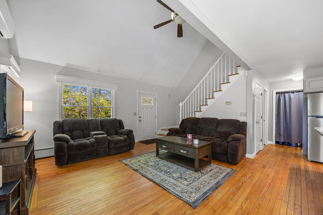 1343 Baldwin Hill Rd, Ledyard, CT 06335 - living room featuring stairs, light wood-style flooring, ceiling fan, a baseboard radiator, and a towering ceiling