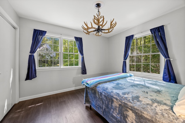 1343 Baldwin Hill Rd, Ledyard, CT 06335 - bedroom featuring a chandelier, multiple windows, baseboards, and wood finished floors