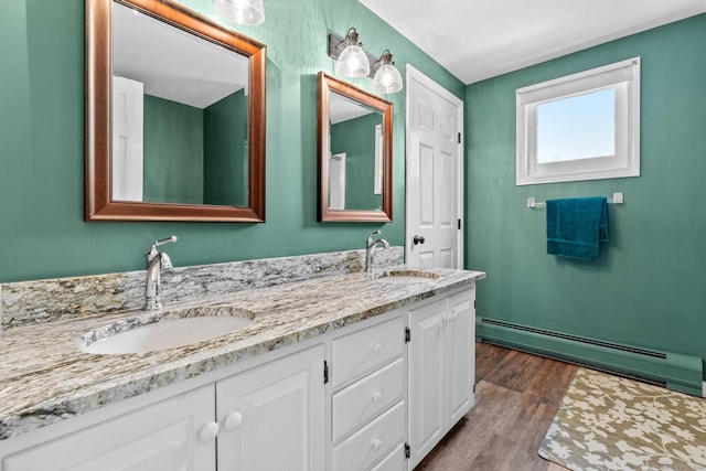 309 N Grand St, Suffield, CT 06093 - bathroom with baseboard heating, double vanity, and wood finished floors