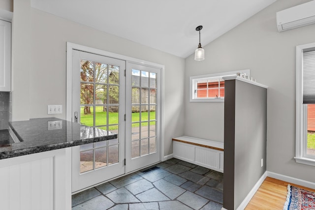309 N Grand St, Suffield, CT 06093 - doorway with an AC wall unit, vaulted ceiling, and baseboards