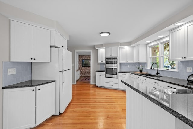 309 N Grand St, Suffield, CT 06093 - kitchen featuring a sink, baseboards, light wood-type flooring, and white cabinets