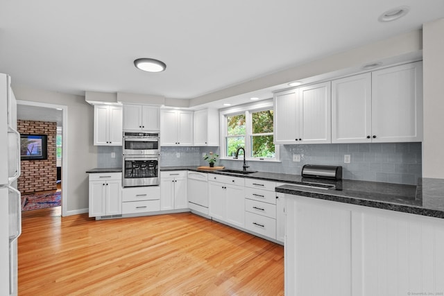309 N Grand St, Suffield, CT 06093 - kitchen featuring a sink, dishwasher, light wood-style flooring, and white cabinets